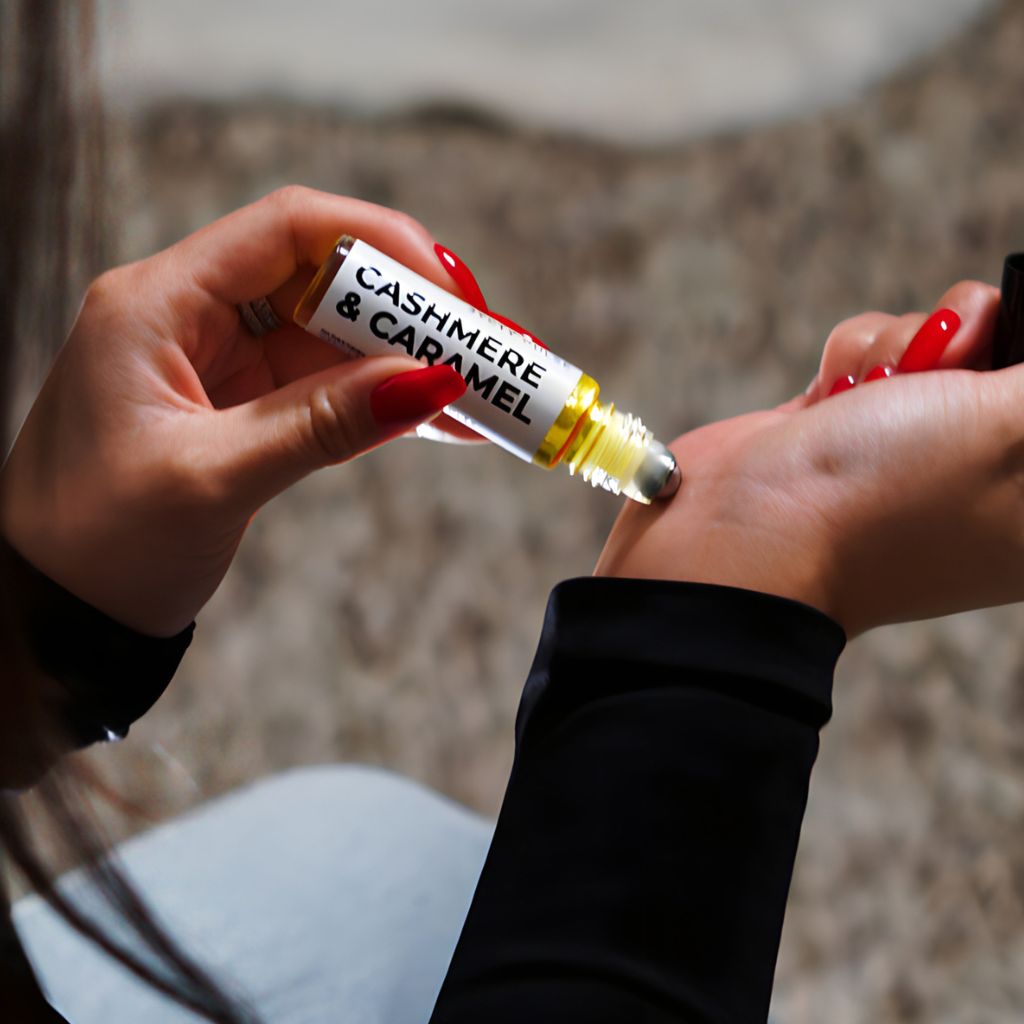 vanille supreme roll on perfume oil dabbing on her wrist
